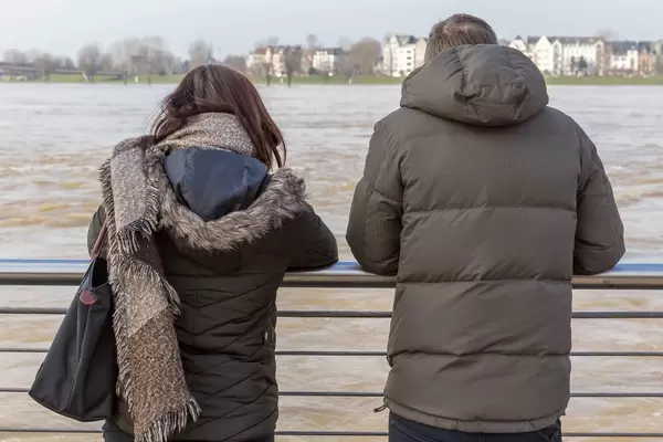 Ehepaar betrachtet den trüben Rhein