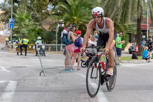 Ein Athlet fährt barfuß auf einem Rad bei einem Triathlon