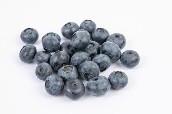 Ein Berg reifer Blaubeeren auf weißer Fläche