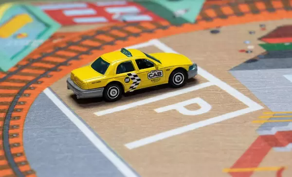 Ein gelbes Taxi auf einem Parkplatz - Modelauto