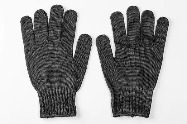 Ein Paar Handschuhe in schwarz auf weißem Hintergrund
