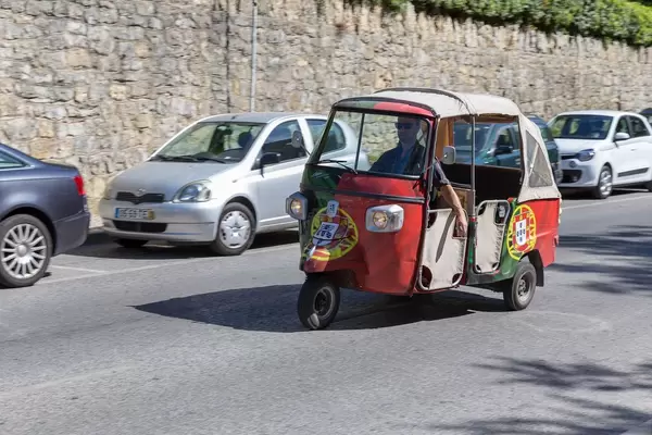Ein Piaggio Tuk Tuk mit der portugiesischen Flagge als Lakierung
