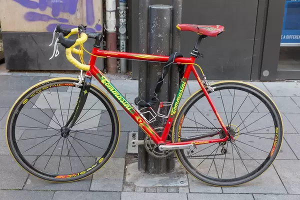 Ein rotes Tommasini Rennfahrrad an eine Straßenlaterne gekettet