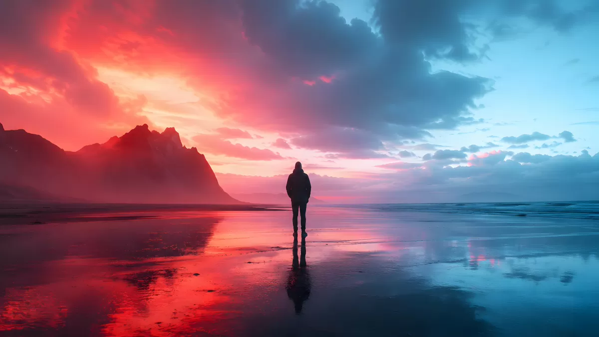 Einsame Silhouette am Strand zwischen Rot und Blau