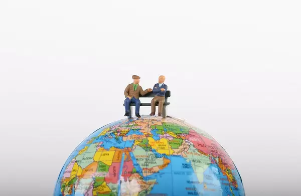Elderly people sitting on globe