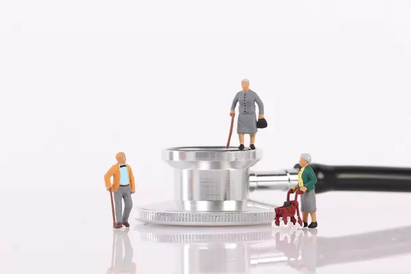 Elderly people with stethoscope on white background