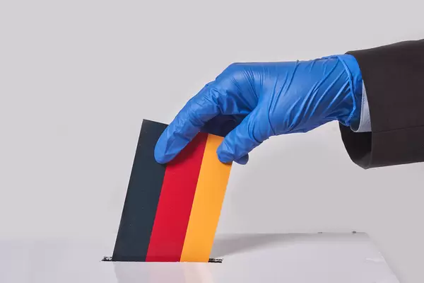 Elections - Hand of a person putting vote in the ballot box