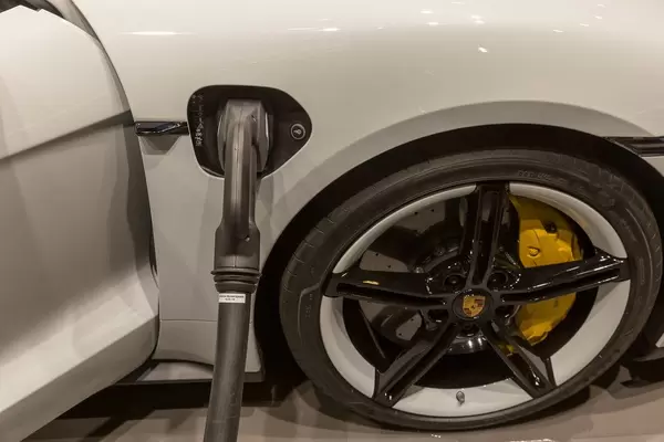Electric car charging with CCS plug on Porsche Taycan Turbo S e-sports car