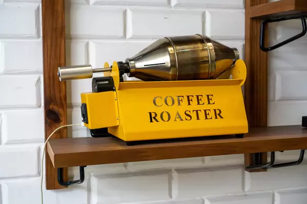 Electric Coffee Bean Coffee Roaster Machine on a Wooden Shelf in a Cafe