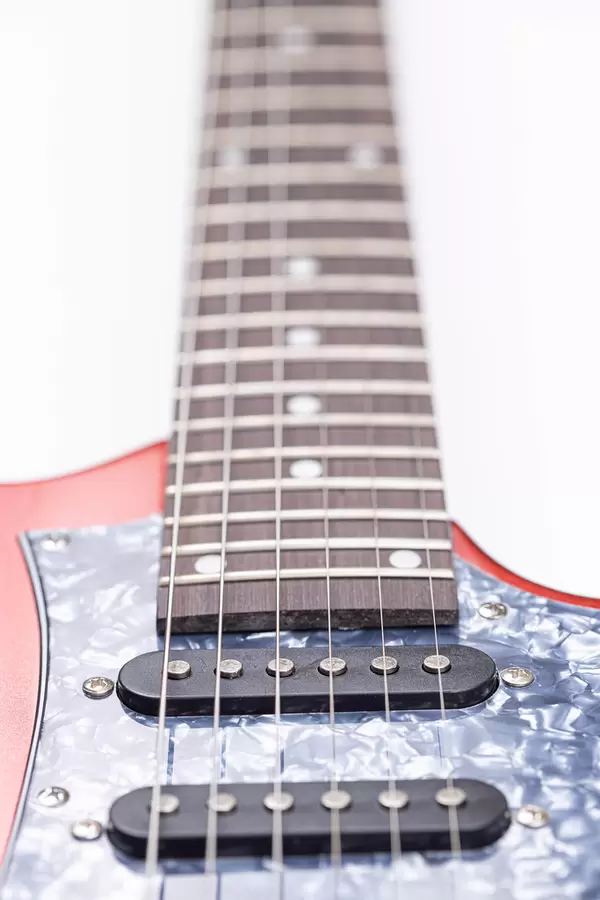 Electric Guitar and Neck with Frets above white background