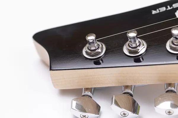 Electric Guitar Head closeup above white background