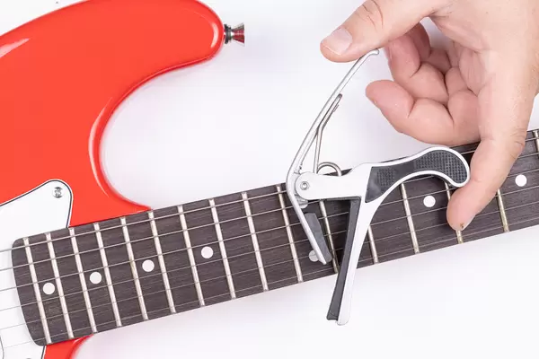 Electric Guitar with Capodastro in the hand