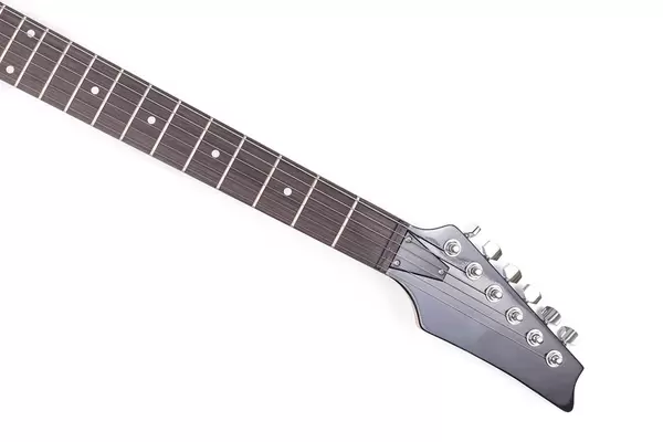 Electric Guitar's neck and head above white background with copy space