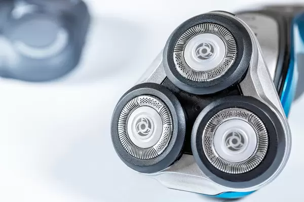 Electric shaver closeup on white background
