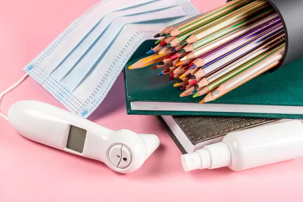Electric thermometer, mask and antiseptic with school supplies