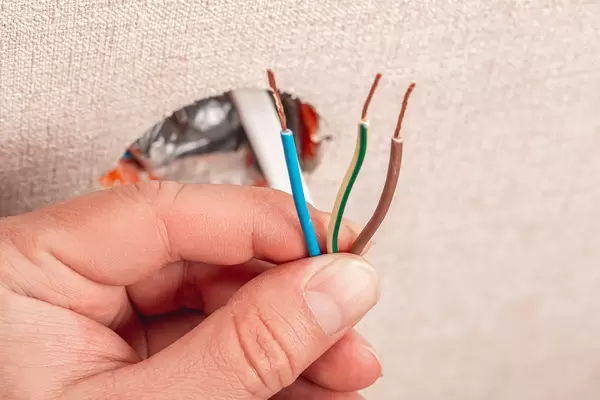 Electro wires in hand, home repair concept
