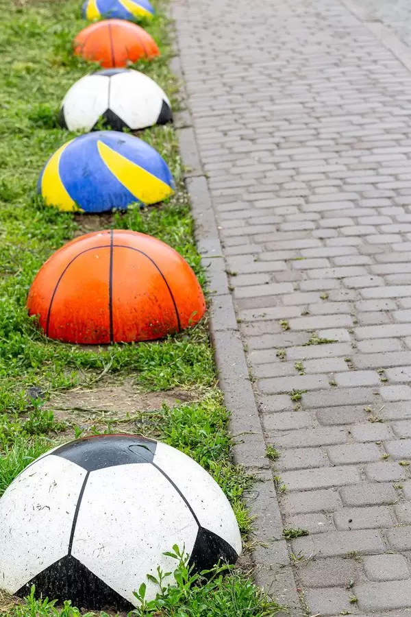 Element of sidewalk design and protection from car parking in the form of balls