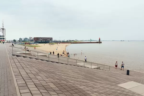 Embarkment and the beach with the lighthouse in German sea town of Bremerhaven