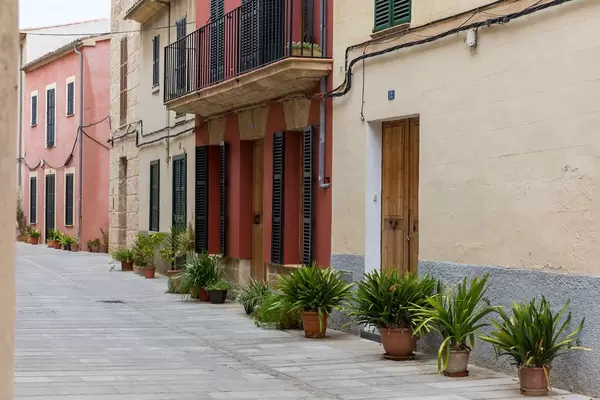 Empty alley with plants in front of houses in the beautiful town of Alcudia in the north of Majorca