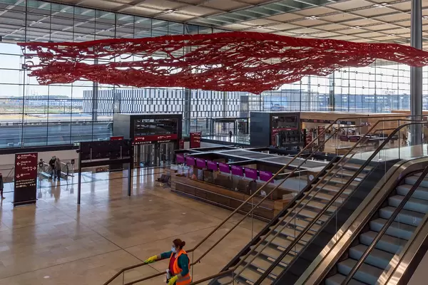 Empty check-in hall at Terminal 1 of the new BER airport in Berlin with work of art "The magic carpet"