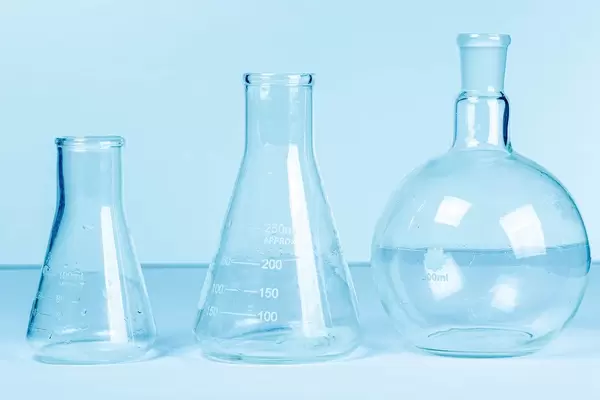 Empty flasks on a light blue background. Laboratory glassware