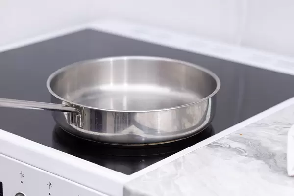 Empty Frying Pan on the modern Stove with induction plate