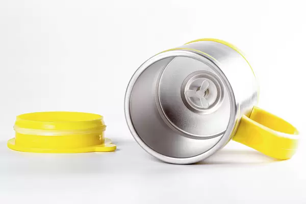 Empty metal mug mixer on white background with yellow lid