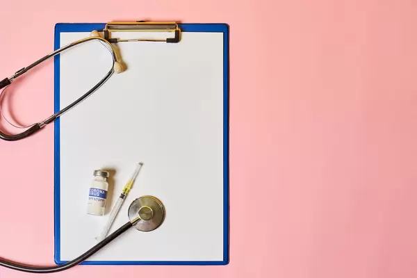 Empty paper with a stethoscope and covid vaccine