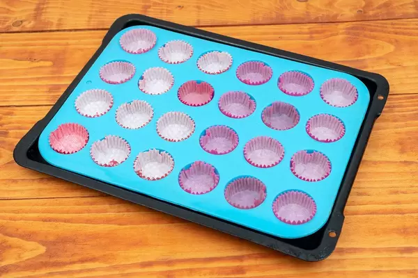 Empty papers for muffins on the baking tray (Flip 2020)