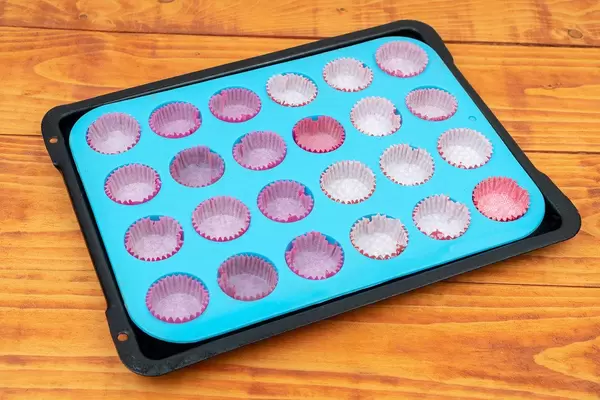 Empty papers for muffins on the baking tray