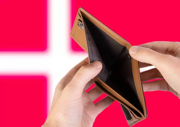 Empty Wallet with Flag of Denmark. Recession and Financial Crisis to come with more debt and federal budget deficit?