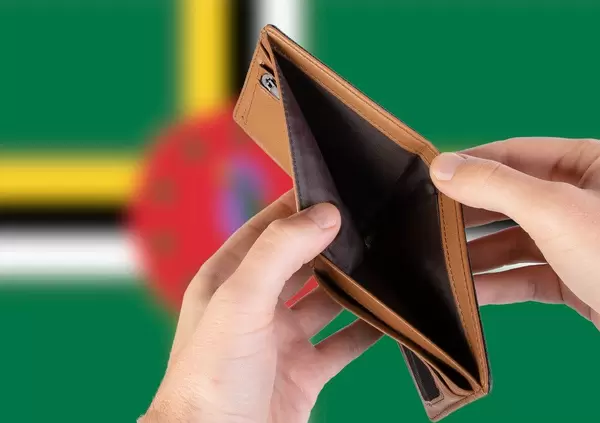 Empty Wallet with Flag of Dominica. Recession and Financial Crisis to come with more debt and federal budget deficit?