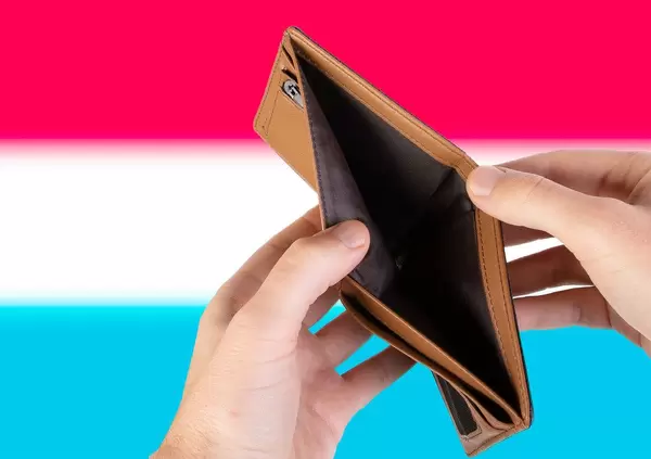 Empty Wallet with Flag of Luxembourg. Recession and Financial Crisis to come with more debt and federal budget deficit?