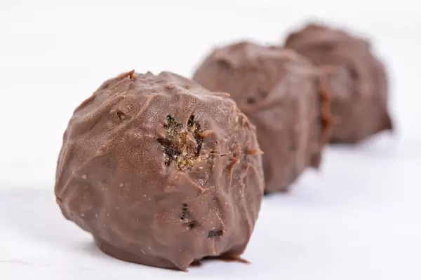 Energy Balls with Chocolate Glaze above white background