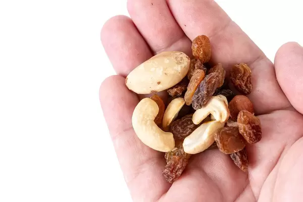Energy mix with raisins hazelnuts cashew and brazilian nuts in the hand (Flip 2019)