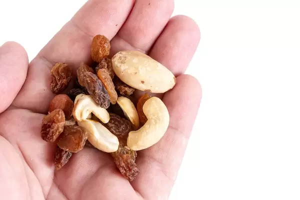 Energy mix with raisins hazelnuts cashew and brazilian nuts in the hand