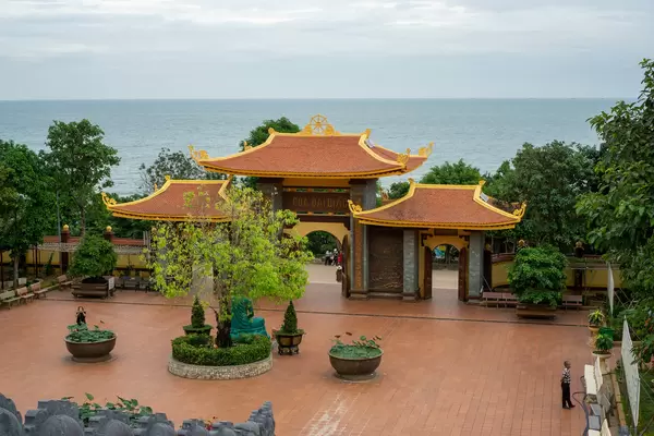 Entrance Gate, Large Courtyard, Trees, Plants and Buddhist Statues with a View to the Ocean at Ho Quoc Temple in Phu Quoc, Vietnam