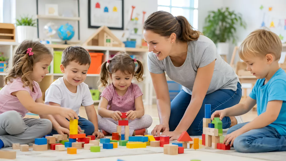 Erzieherin spielt mit Kindern im Kindergarten Bauklötze