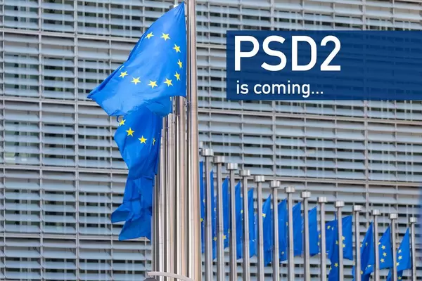 EU flags waving in front of European Parliament building with PSD2 is coming text