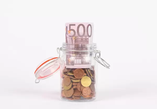 Euro banknotes in a glass jar