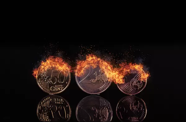 Euro coins burning in fire