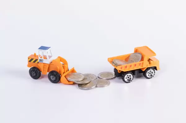Excavator and truck with 2 Euro money coins