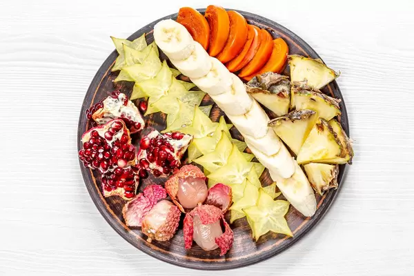 Exotic ripe fruit slices on a plate. The view from the top (Flip 2019)