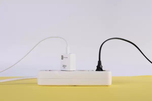Extension cord on yellow and white background