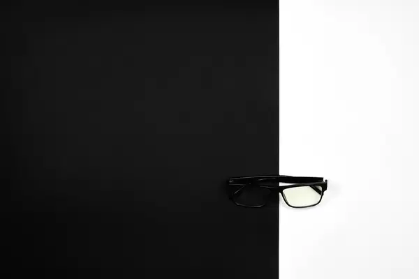Eyeglasses on black and white. Creative vision concept.