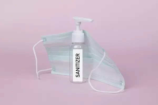 Face mask with sanitizer bottle