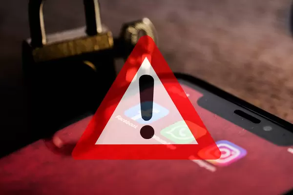 Facebook, Instagram and WhatsApp mobile application on phone screen with Warning symbol