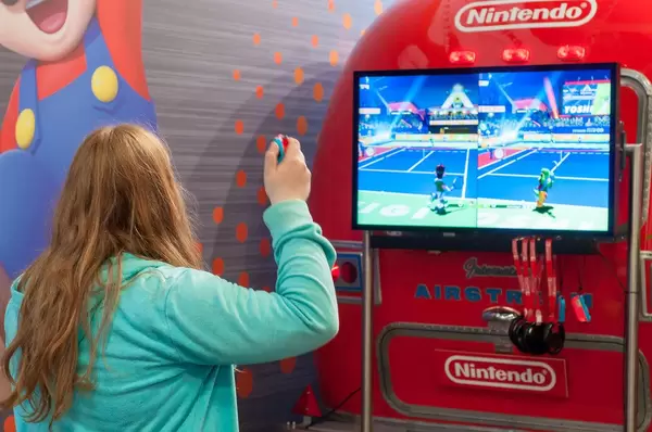 Fair visitor playing Mario Tennis Aces for Nintendo Switch