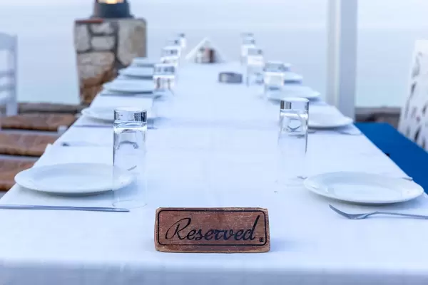 Family dinner: reserved table with white tablecloth in a restaurant