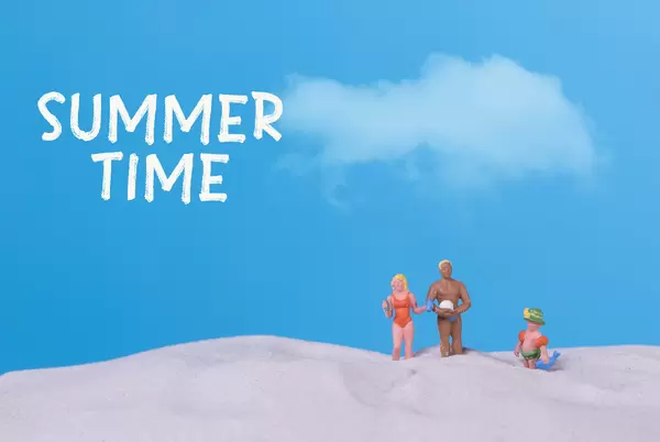 Family on the beach with Summer time text